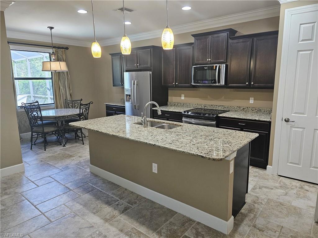 10840 Rutherford Road Fort Myers, FL 33913 - Photo 18 of 35 Tiled spare room with crown molding and ceiling fan with notable chandelier