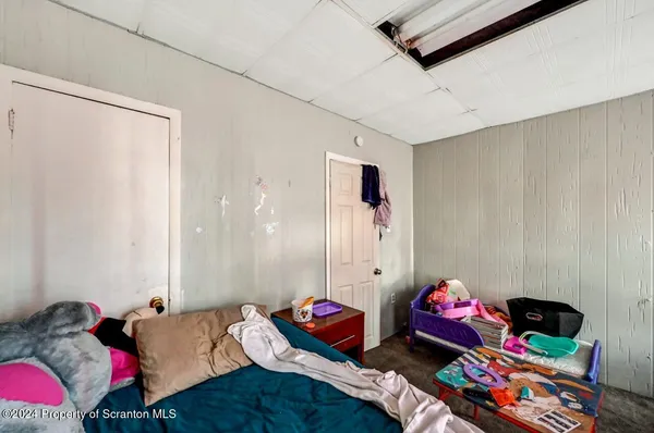 a bedroom with furniture and a flat screen tv