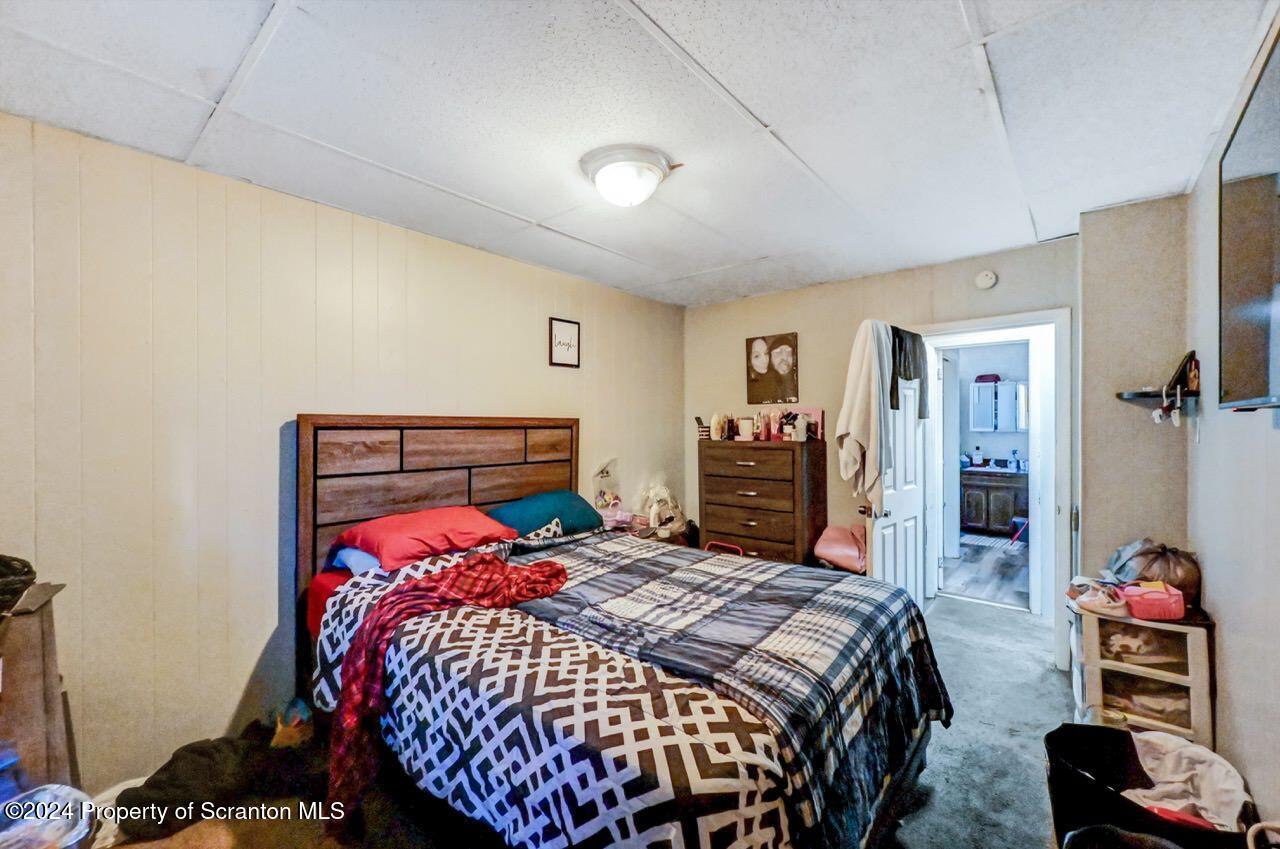 938 Providence Road Scranton, PA 18508 - Photo 20 of 22 a bed sitting in a bedroom next to a window