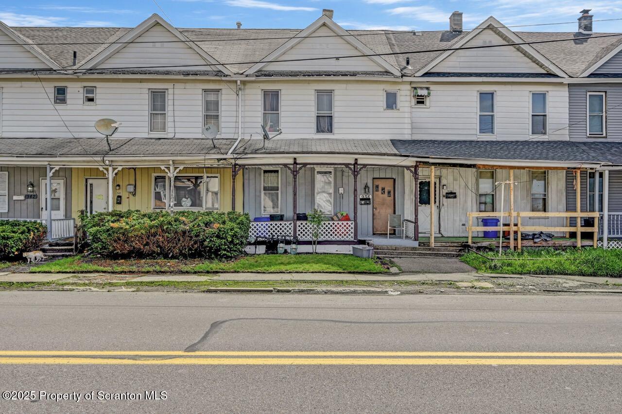 938 Providence Road Scranton, PA 18508 - Photo 2 of 22 a front view of a house with a yard and potted plants