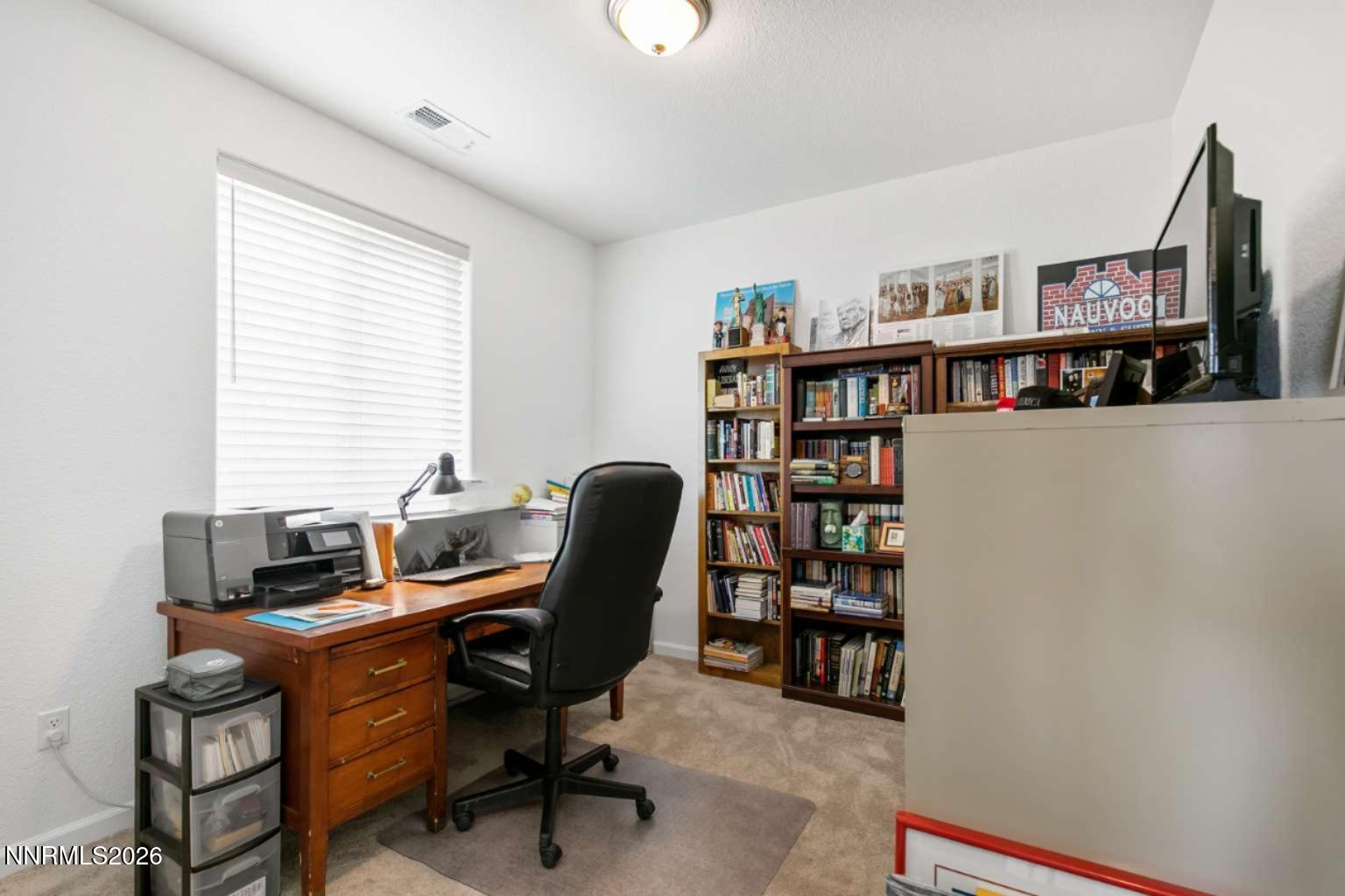 3274 Eleanor Way Fernley, NV 89408 - Photo 15 of 17 a view of a workspace with a bookshelf