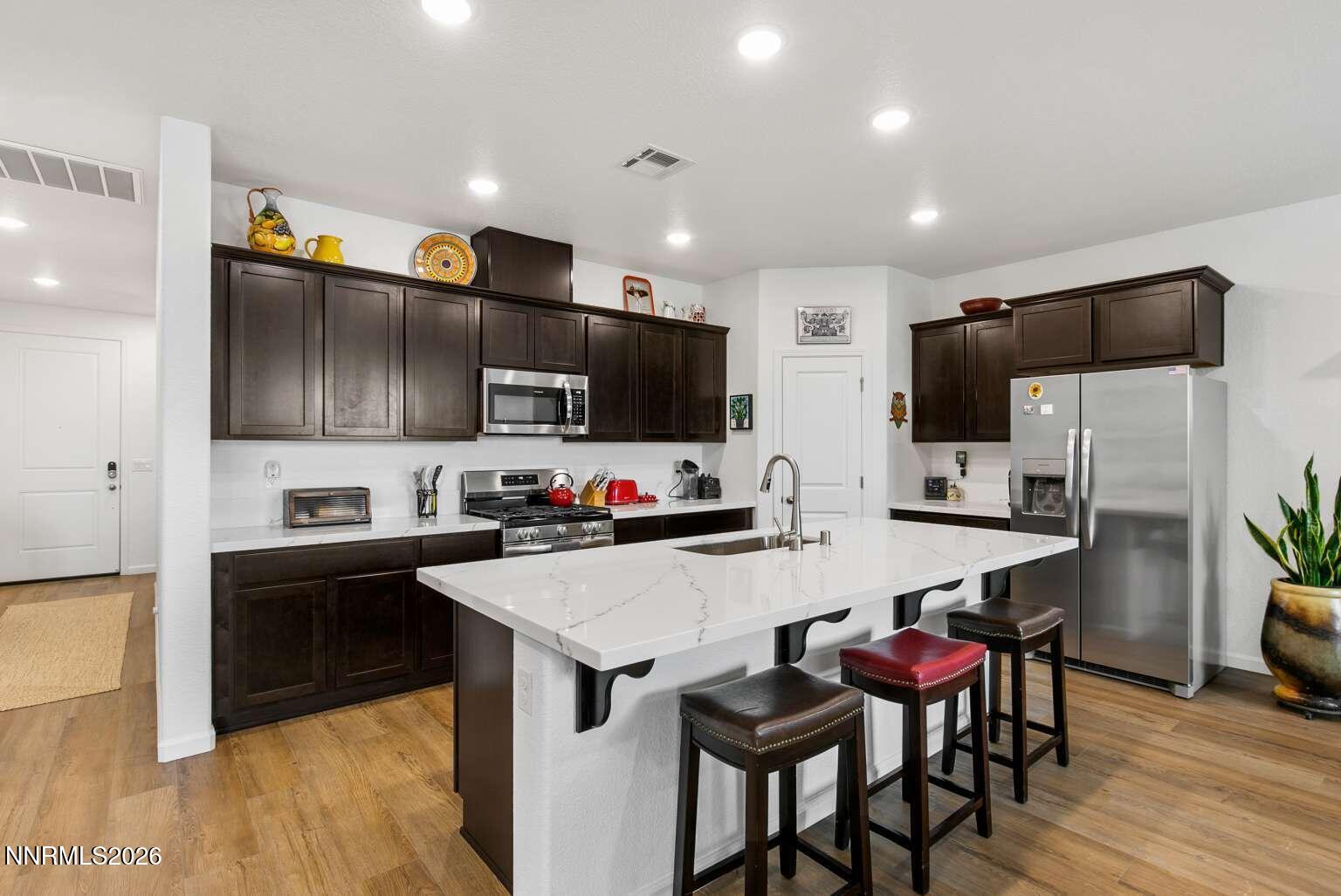 3274 Eleanor Way Fernley, NV 89408 - Photo 4 of 17 a kitchen with stainless steel appliances a microwave sink and refrigerator