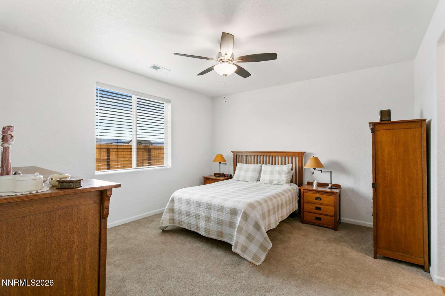 3274 Eleanor Way Fernley, NV 89408 - Photo 8 of 17 a bedroom with a bed and a table