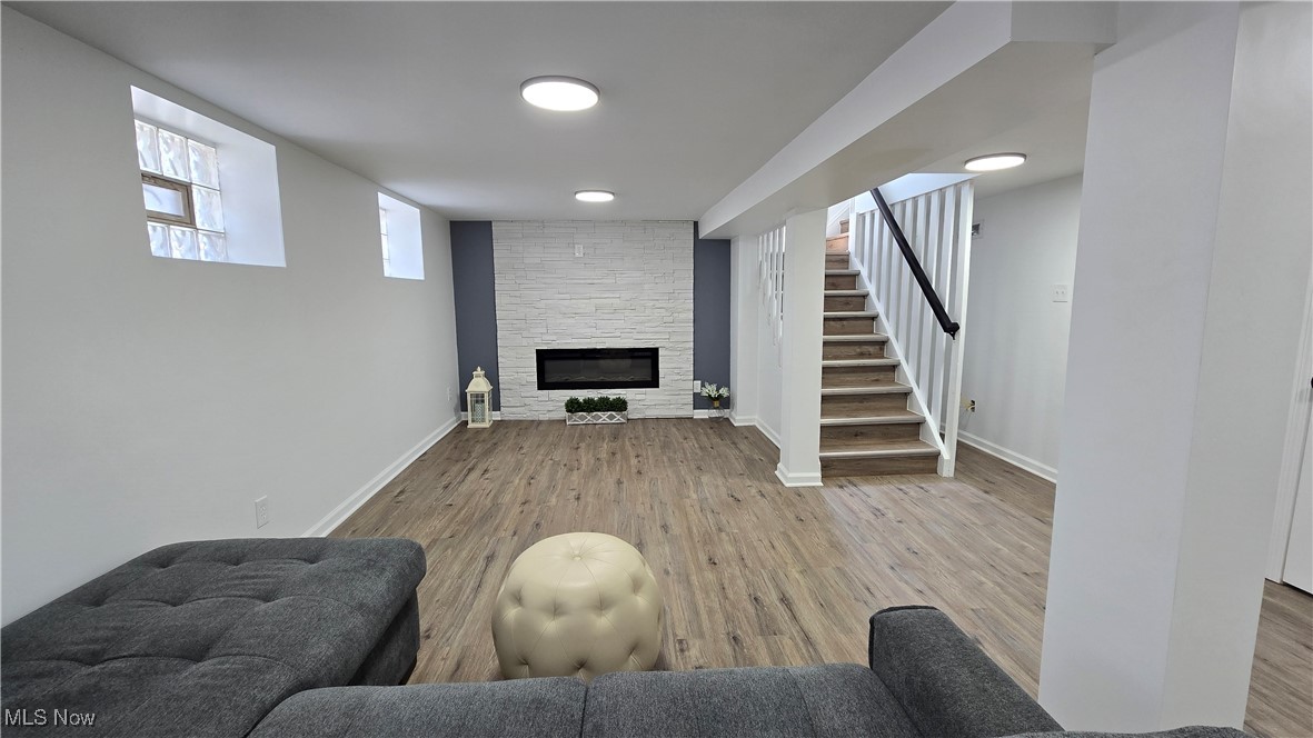 3388 Cedarbrook Road Cleveland, OH 44118 - Photo 12 of 14 Living area with a stone fireplace, wood finished floors, stairway, and baseboards