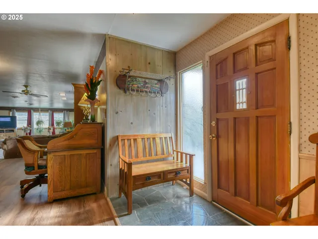 a living room with furniture a rug and a window
