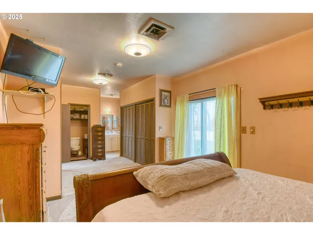 a bedroom with a bed and a mirror