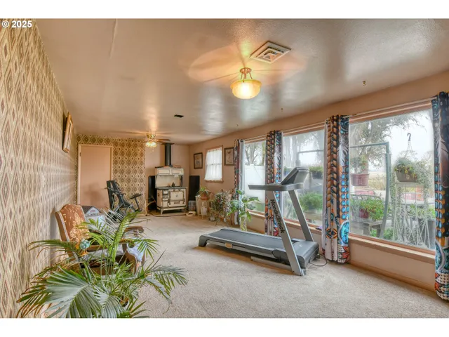 a living room with furniture and large windows