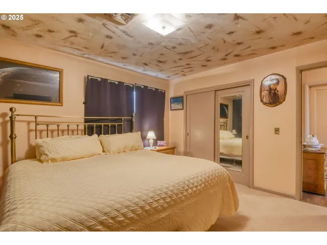 a bedroom with a bed and a night stand