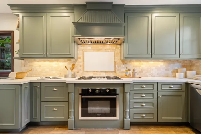 a kitchen with a sink appliances and wooden floor