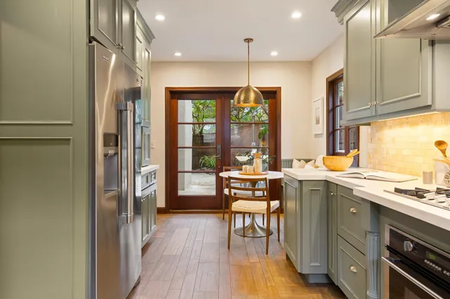 a dining room with furniture a rug and a large window