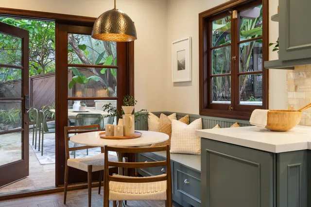 a dining room with furniture and wooden floor