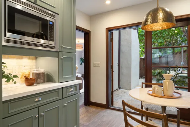 a view of a patio with table and chairs and potted plants