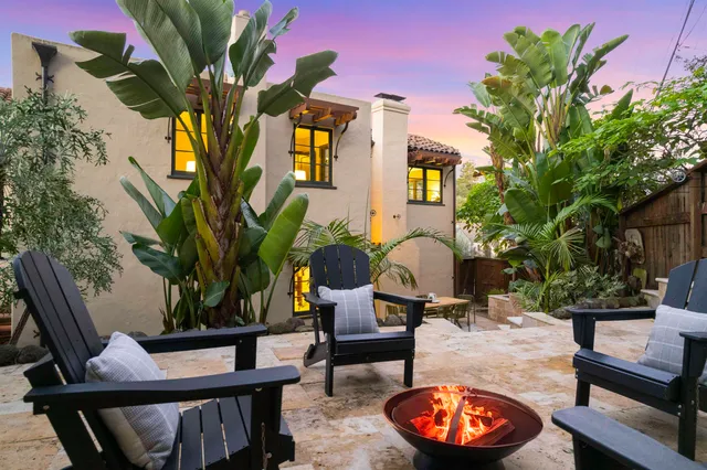 a view of balcony with two chairs and a potted plant