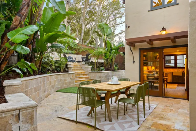 a view of house with backyard and sitting area