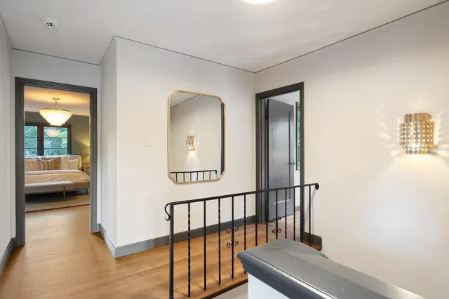 a bedroom with a large bed and a chandelier