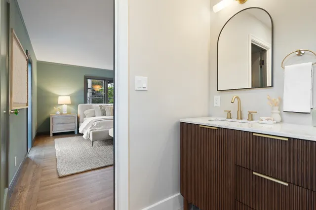 a bathroom with a double vanity sink mirror and bathtub