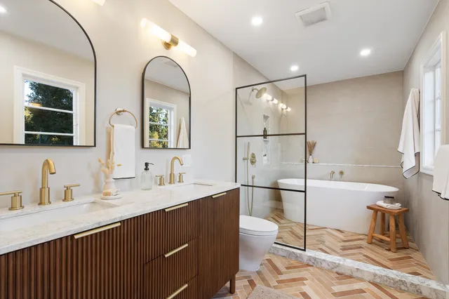 a room with two beds and a large window