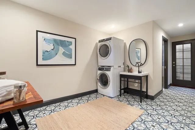 a view of a two chairs in the back yard of the house