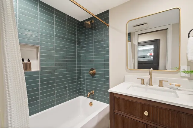 a view of a patio with couches table and chairs with wooden fence and plants