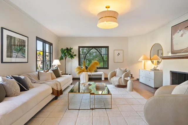 a living room with furniture fireplace and window