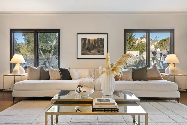 a living room with furniture a fireplace and wall paintings