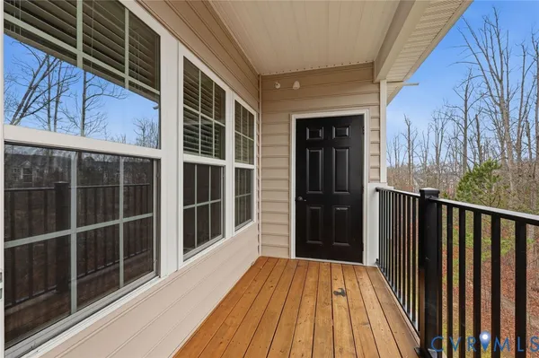 a view of balcony with wooden floor and fence