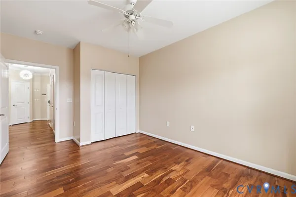 a view of an empty room with wooden floor