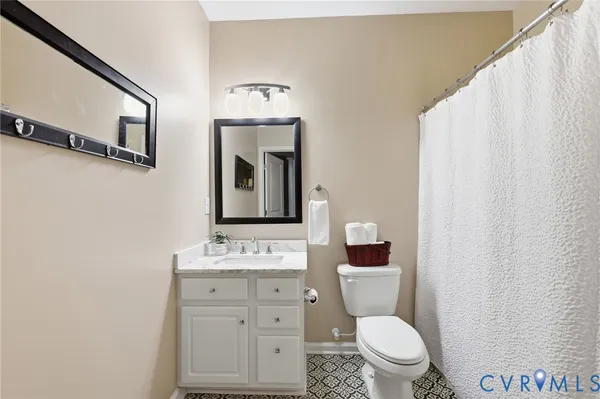 a bathroom with a toilet a sink and a mirror