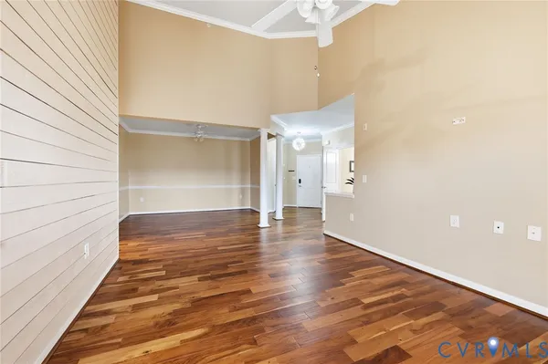 a view of an empty room and wooden floor