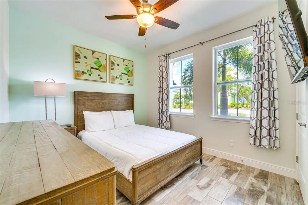 8209 Surf Street Kissimmee, FL 34747 - Photo 11 of 74 a bedroom with a bed and a chandelier