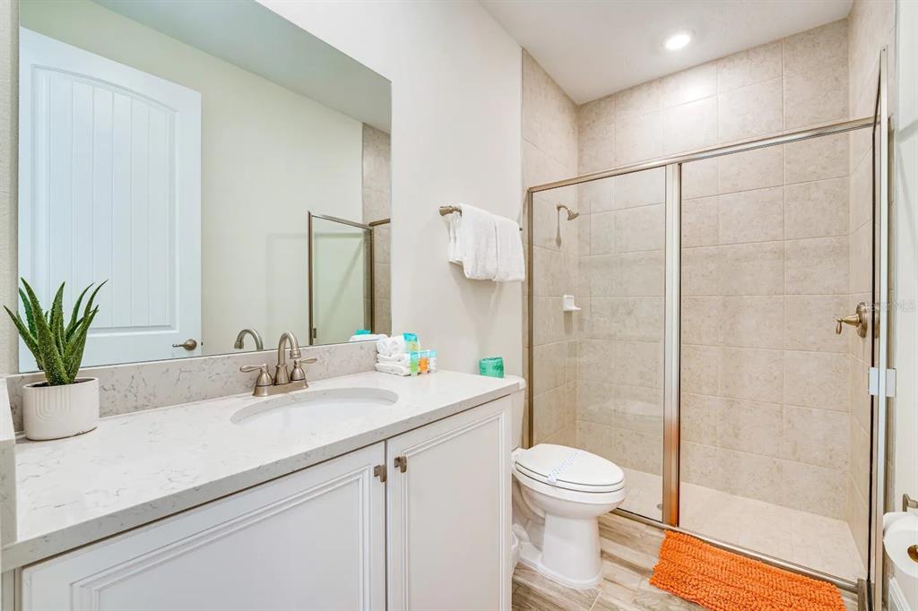 8209 Surf Street Kissimmee, FL 34747 - Photo 12 of 74 a bathroom with a sink a toilet and shower