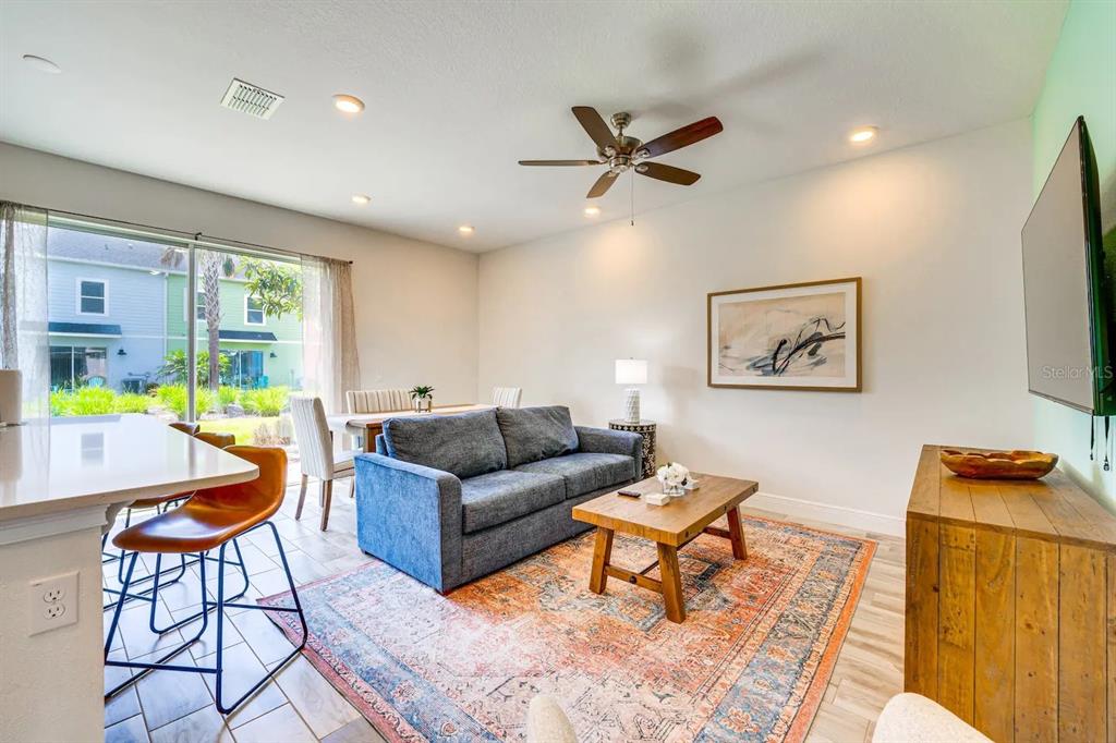 8209 Surf Street Kissimmee, FL 34747 - Photo 2 of 74 a living room with furniture and a wooden floor