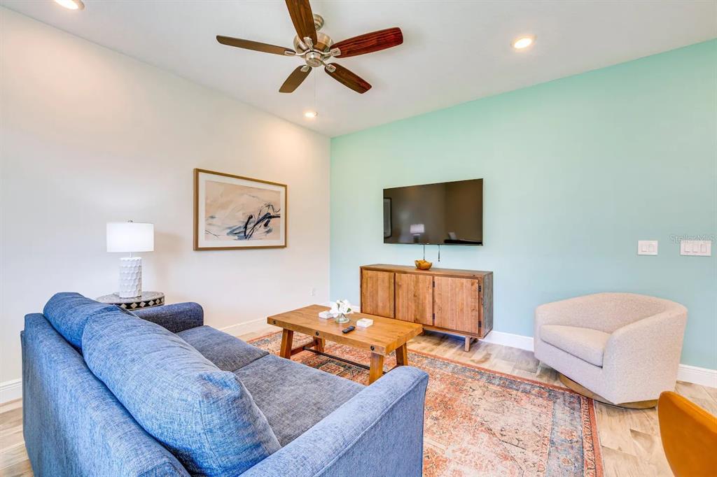 8209 Surf Street Kissimmee, FL 34747 - Photo 3 of 74 a living room with furniture and a flat screen tv