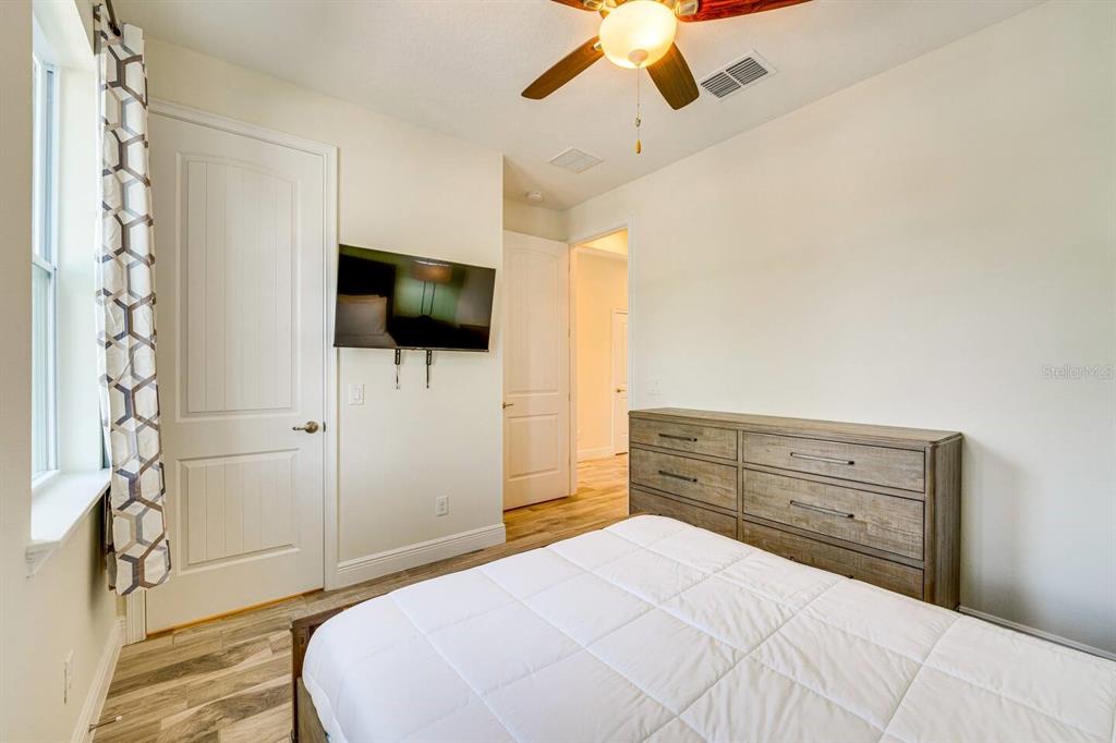8209 Surf Street Kissimmee, FL 34747 - Photo 10 of 74 a bedroom with a bed and a flat screen tv