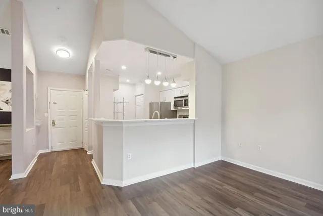 a view of a kitchen with wooden floor and a sink