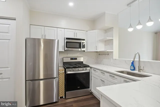 a kitchen with a refrigerator sink and microwave
