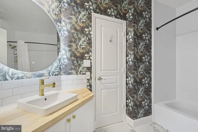 a bathroom with a sink and a mirror