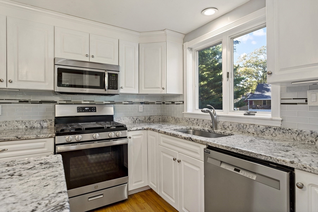10 Briar Patch Lane Mashpee, MA 02649 - Photo 12 of 38 a kitchen with granite countertop a sink stove and microwave