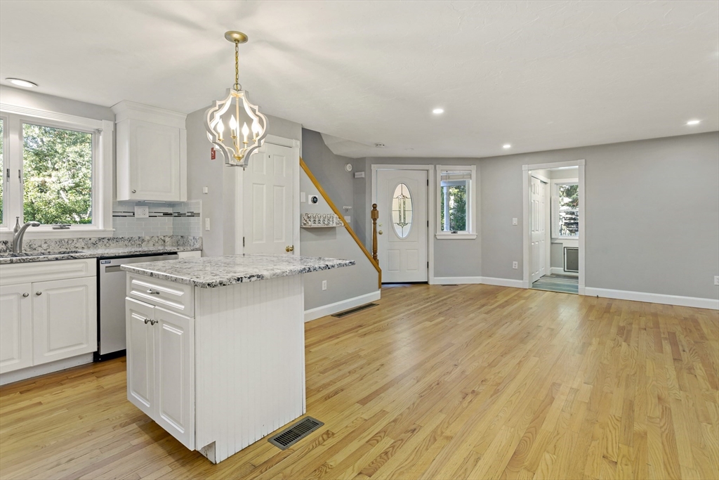 10 Briar Patch Lane Mashpee, MA 02649 - Photo 8 of 38 a open kitchen with white cabinets and wooden floor