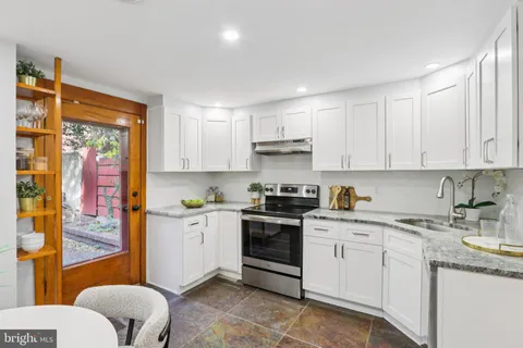 a kitchen with stainless steel appliances granite countertop a sink and cabinets