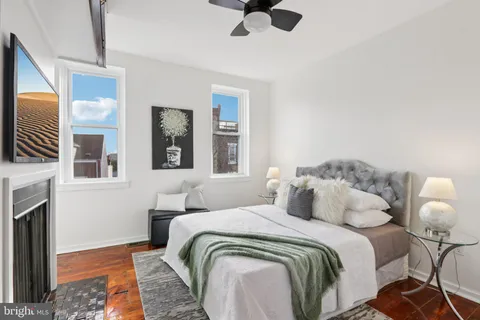 a bedroom with bed and a fireplace