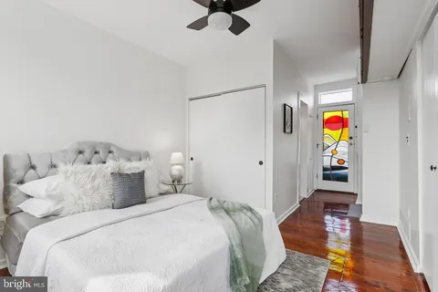 a bedroom with a bed and a painting on the wall