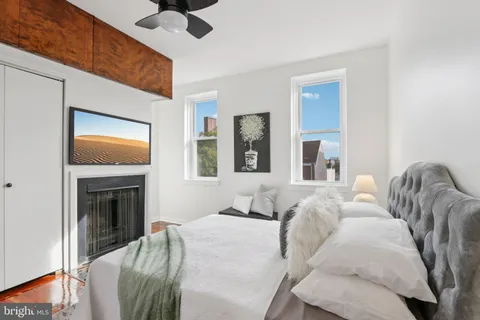 a bedroom with a bed and a fireplace