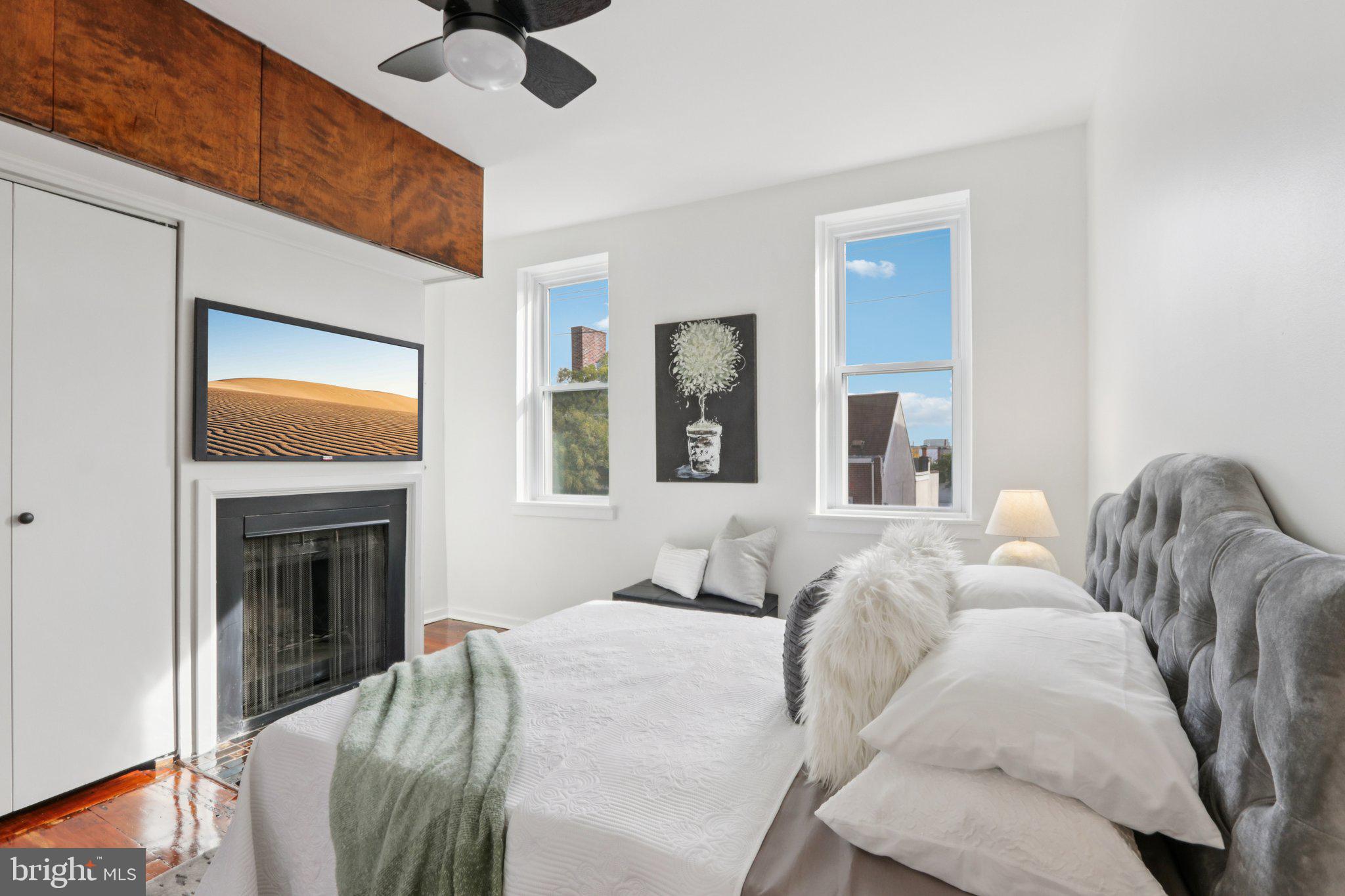 764 South Front Street Philadelphia, PA 19147 - Photo 26 of 46 a bedroom with a bed and a fireplace