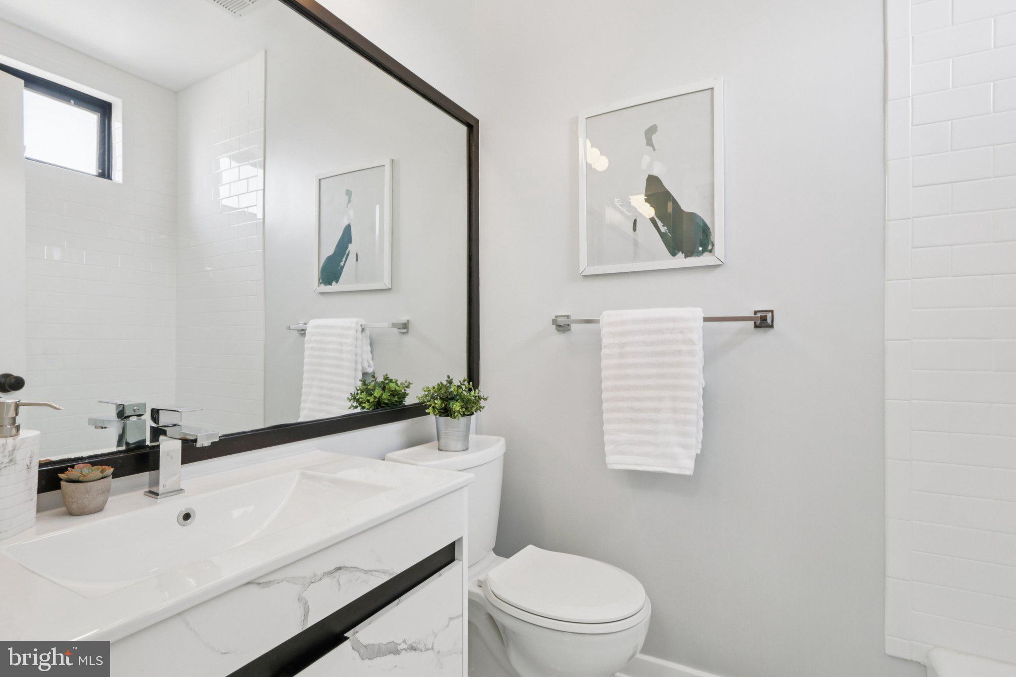 764 South Front Street Philadelphia, PA 19147 - Photo 27 of 46 a bathroom with a sink a toilet and mirror