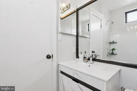 a bathroom with a sink and mirror