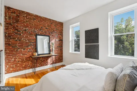 a bedroom with a bed and a large window