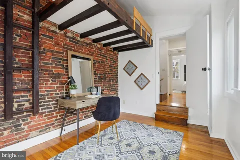 a workspace room with furniture and wooden floor
