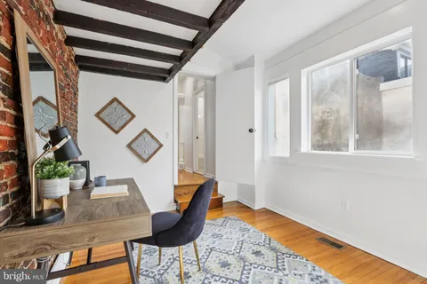 a dining room with furniture and wooden floor