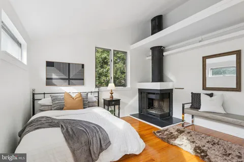 a bedroom with a bed and a fireplace